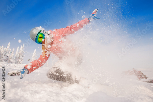 Snowboarder on snowboard rides through snow, explosion.