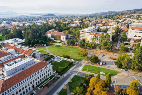 Aerial view of buildings in University of California, Berkeley campus on a sunny autumn day, view towards Richmond and the San Francisco bay shoreline in the background, California photo