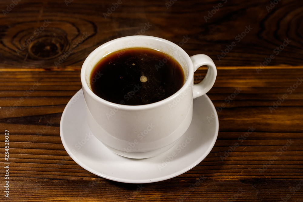 Cup of coffee on the wooden table