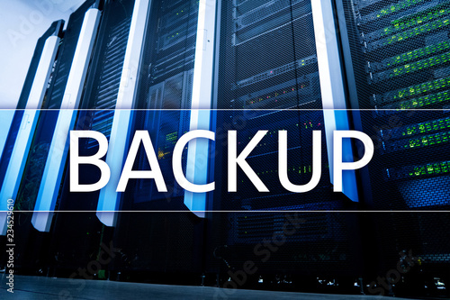 Backup button on modern server room background. Data loss prevention. System recovery. © Funtap