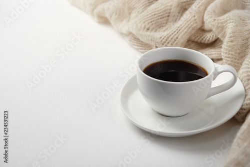A Cup of fragrant black coffee and a textured wool blanket. Warm tone