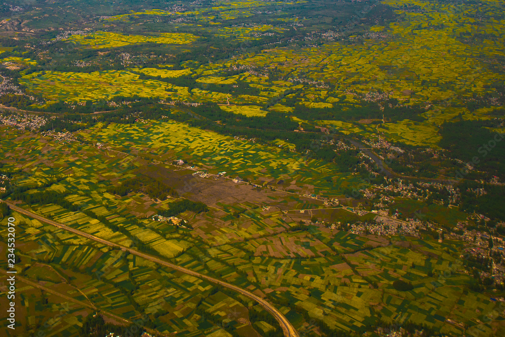 Beautiful valley of Kashmir, India. Stunning view of mustard field on the ground ,tourist and travel concept.(view from aircraft) Beautiful valley of Kashmir, India. Stunning view of mustard field on the ground ,tourist and travel concept.(view from aircraft)