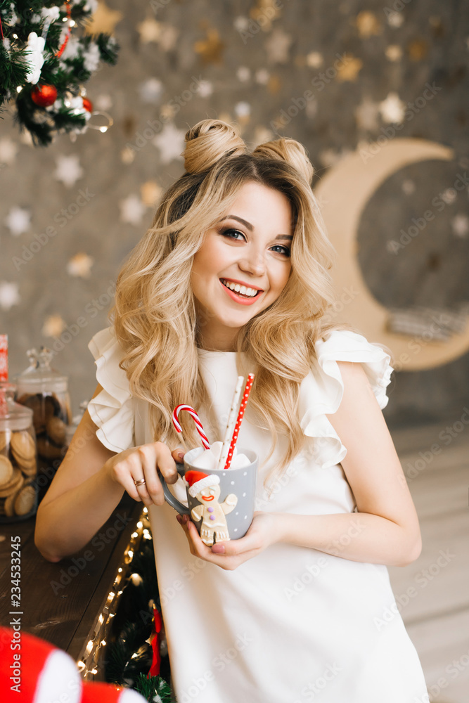 Christmas portrait of a beautiful girl with a red mug on the background of a Christmas bar. New year and Christmas concept
