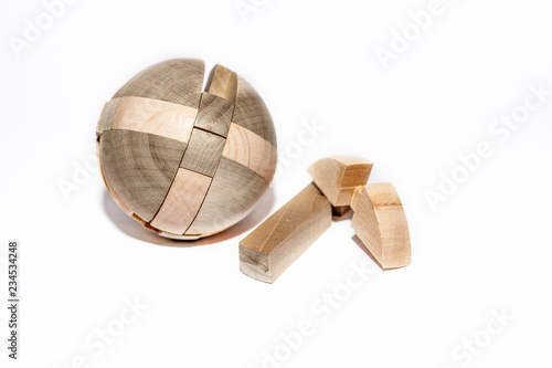 Wooden puzzle on the white background space around in the centre