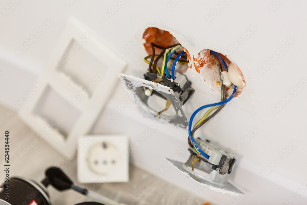 Unfinished electrical mains outlet socket with electrical wires