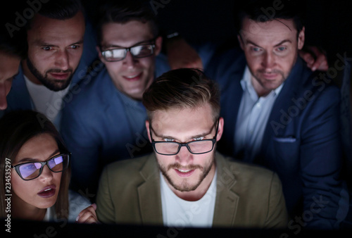 close up.a group of employees working in the office late photo