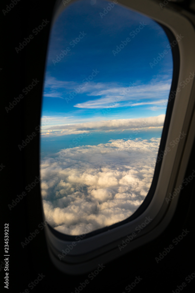Aerial view from airplane window. Aircraft flying above land with beautiful clouds in the blue sky background. Aviation concept. Tourism,Journey,Travel concept. Aerial view from airplane window. Aircraft flying above land with beautiful clouds in the blue sky background. Aviation concept. Tourism,Journey,Travel concept.