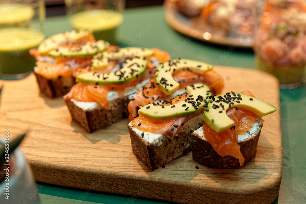 Canapes with salmon and avocado slices