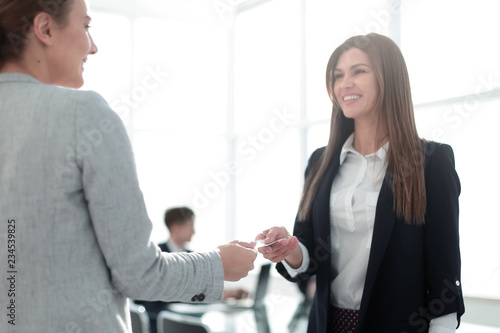 Wallpaper Mural two successful businesswomen exchange their business cards Torontodigital.ca
