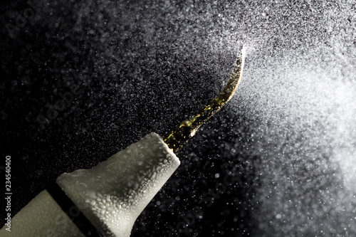 Dental ultrasonic scaler with water splash on black background. Close up.