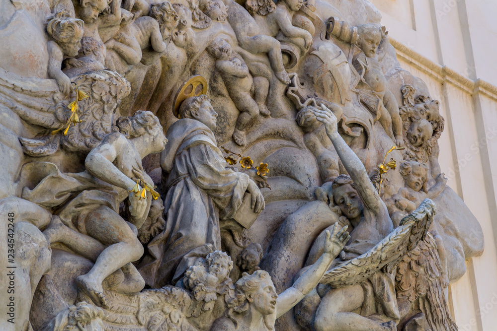Relief sculpture on facade of the Church of Saint James The Greater with Minorite monastery in Old Town of Prague, Czech Republic, sunny day