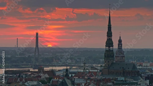 Sunset cityscape of Riga, Latvia. Car traffic on a Stone Bridge, Town hall and the Old city. 4K, UHD