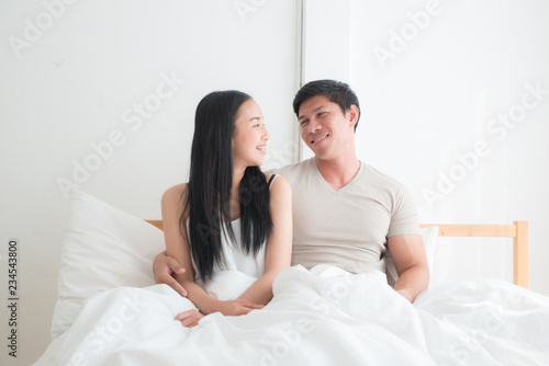 Young lovely couple on the bed together with smiling and happiness. boyfriend,girlfriend, love and valentine concept
