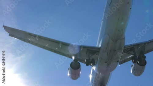 Slow motion shot of undercarriage of commercial jet coming into land. Airbus 319-112. Toronto, Canada. No logos visible. photo