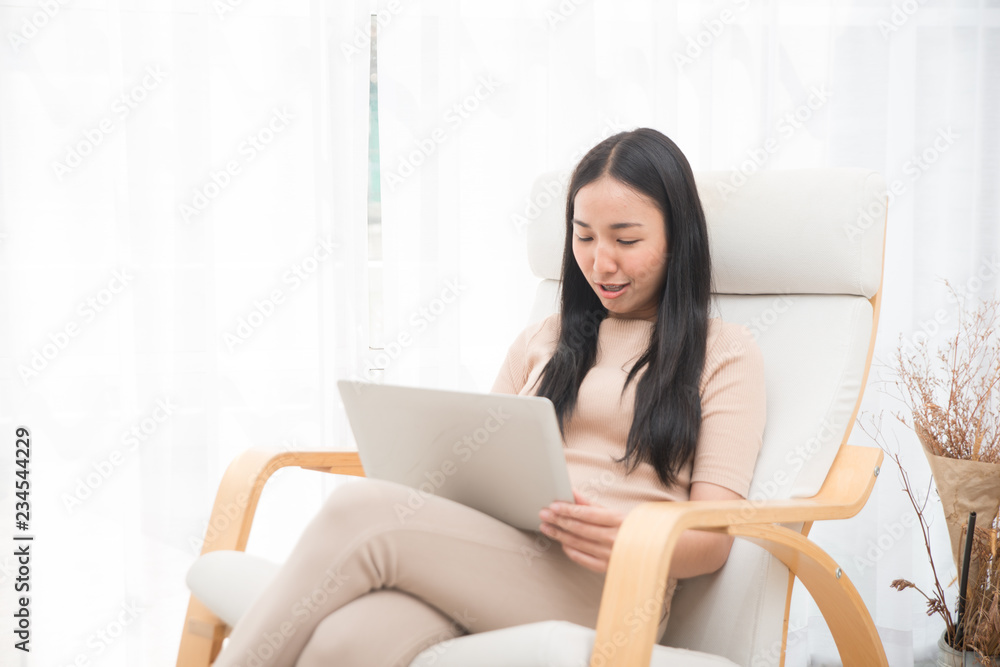 Asian creative business girl in casual dress is doing work on laptop. Business concept. Asian creative business girl in casual dress is doing work on laptop. Business concept.