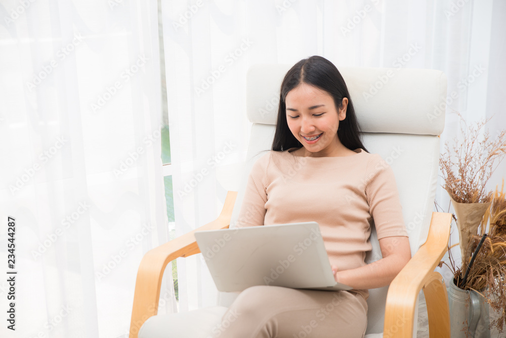 Asian creative business girl in casual dress is doing work on laptop. Business concept. Asian creative business girl in casual dress is doing work on laptop. Business concept.