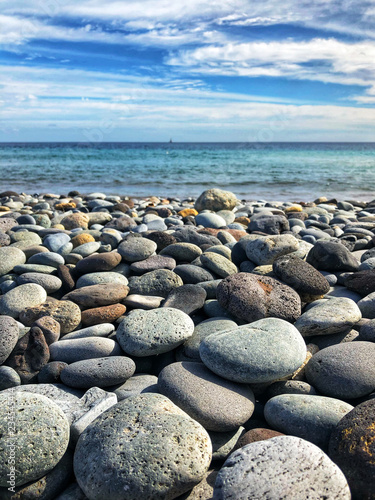pebble stone beach with ocean background -