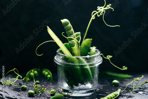 pea pods on a black background