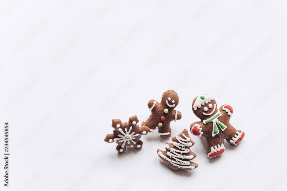 A set of festive traditional Christmas ginger cookies on a white background in minimal style. Near place for text. The concept of celebrating Christmas and New Year. A set of festive traditional Christmas ginger cookies on a white background in minimal style. Near place for text. The concept of celebrating Christmas and New Year.