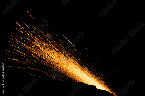 bright fire sprays on a black background from the bottom right corner