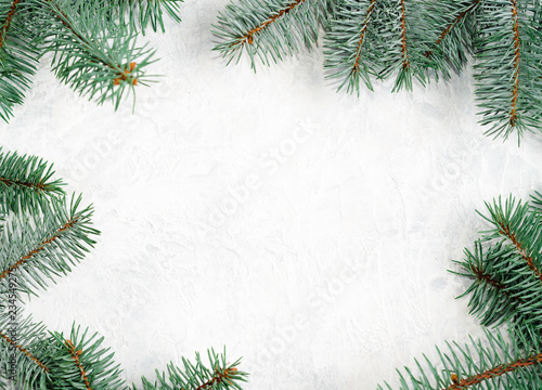 Christmas frame made of branches of a New Year tree. Christmas wallpaper. Flat lay, top view, copy space