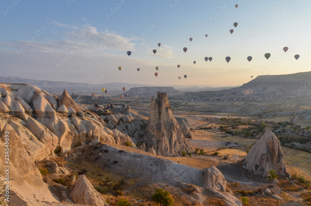 hot air balloons flying over Capadocia at sunrise  Cavusin, Nevsehir province, Turkey