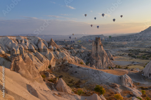 hot air balloons flying over Capadocia at sunrise Cavusin, Nevsehir province, Turkey