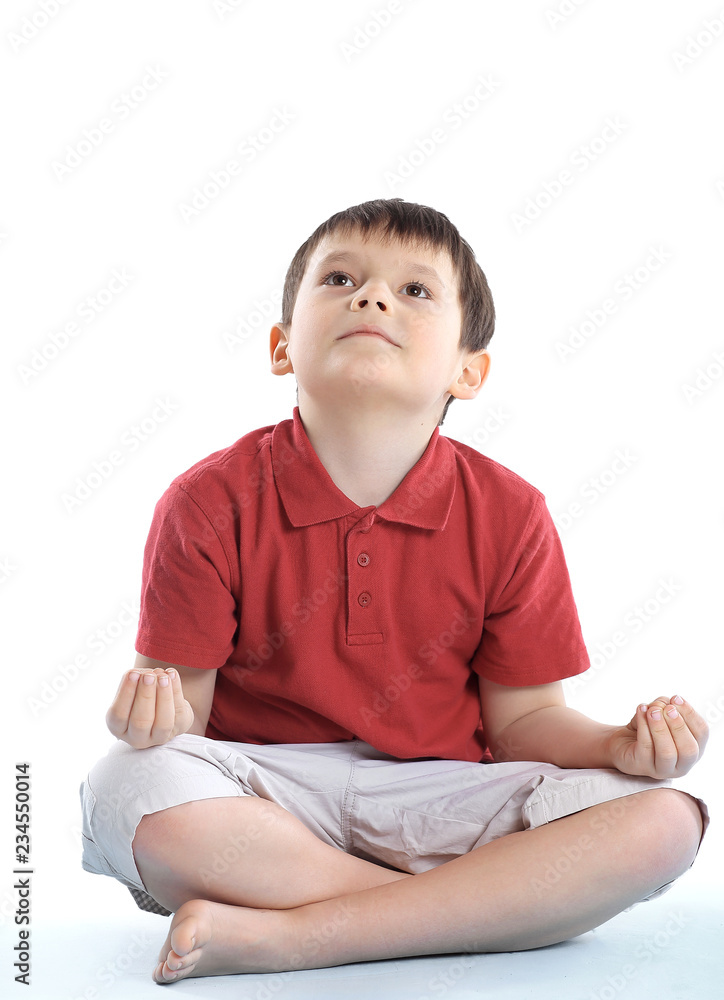 little boy is sitting in the Lotus position.isolated on white little boy is sitting in the Lotus position.isolated on white