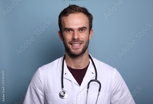 Young doctor in front of a colored background