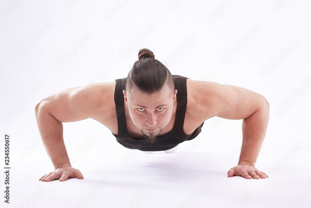 athletic man performs push-up from the floor.isolated on white background athletic man performs push-up from the floor.isolated on white background