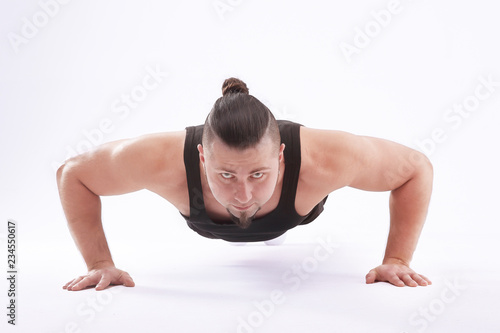 athletic man performs push-up from the floor.isolated on white background