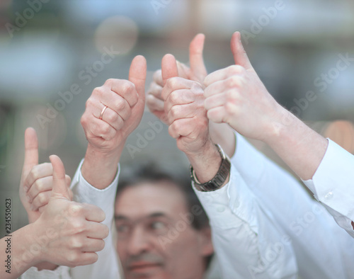 closeup . professional business team business team raising his thumb up