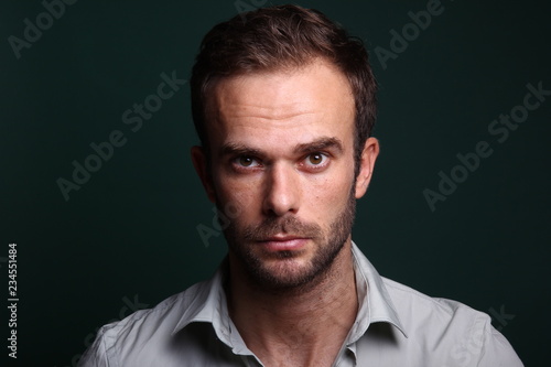 Young man in front of a colored background