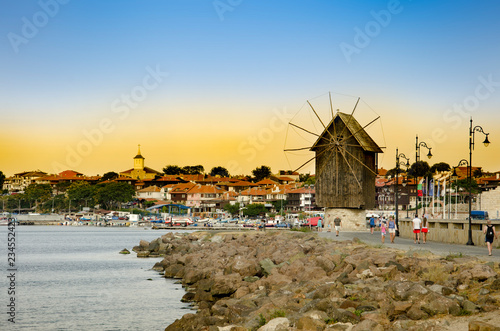 Sunset over old windmill in the ancient town of Nesebar in Bulgaria