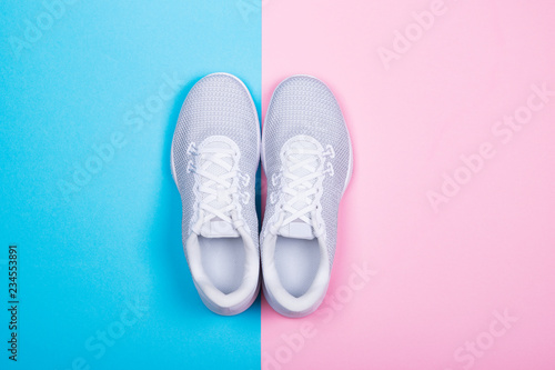 White sneakers on blue and pink background.