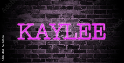 first name Kaylee in pink neon on brick wall