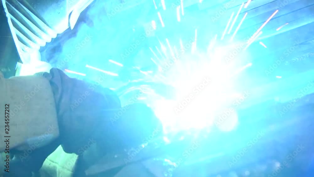 Weld Exploding Welding with sparks by Process fluxed cored arc welding. Industrial ...