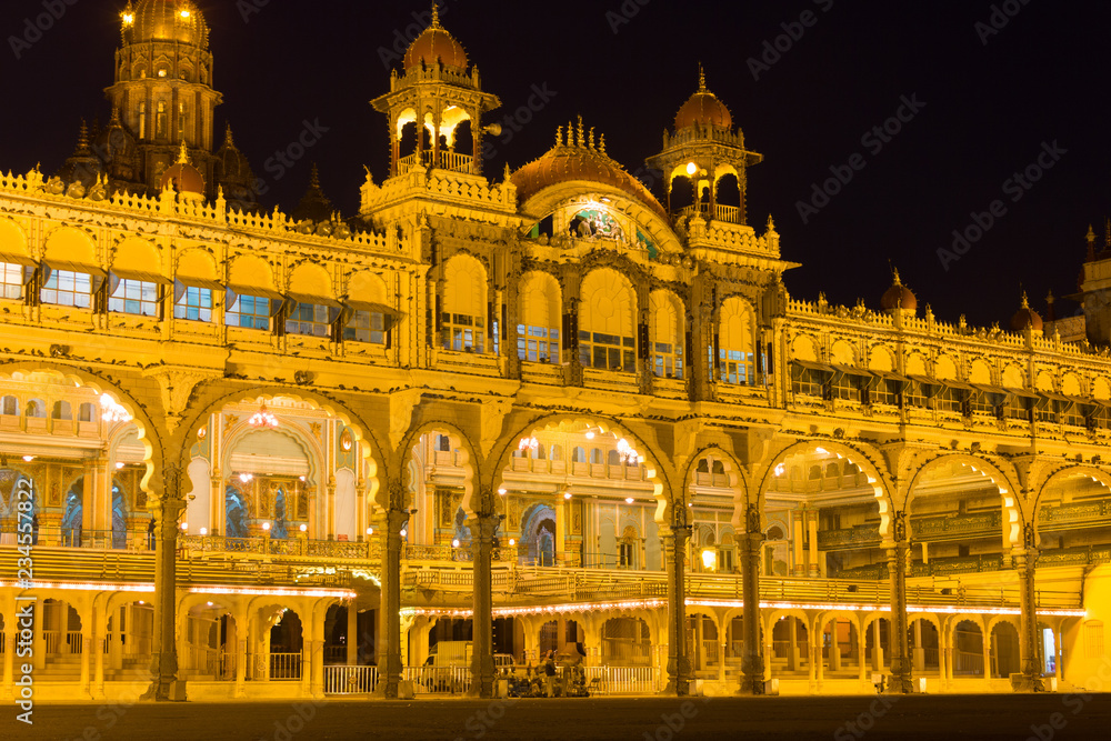 Front facade of Mysore Palace lighted up at night. Iconic landmark in Karnataka, India. Royal building, visit destination concepts