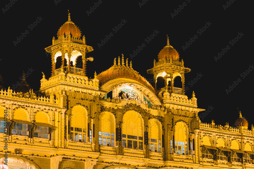 Mysore Palace center domes lighted up at night. Iconic landmark in Karnataka, India. Guided tour, visit destination concepts