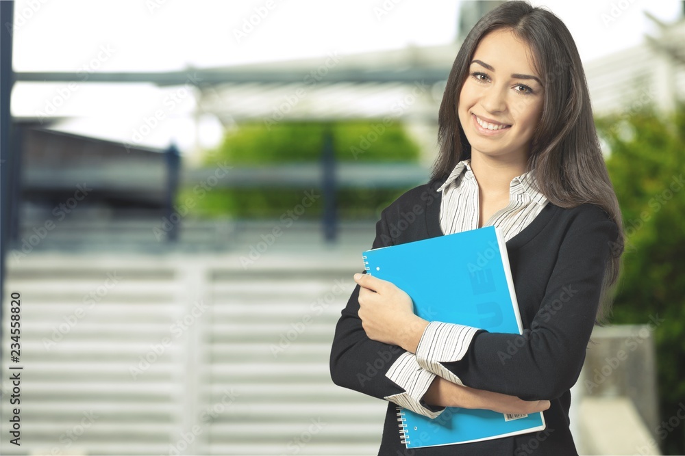 Young beautiful businesswoman on blurred background Young beautiful businesswoman on blurred background