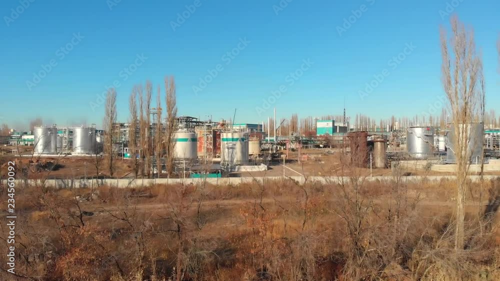 Aerial view of industrial factory or plant buildings with steel storage construction tanks and pipes, oil refinery and chemical manufacturing Aerial view of industrial factory or plant buildings with steel storage construction tanks and pipes, oil refinery and chemical manufacturing