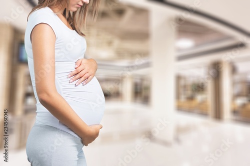 Pregnant young woman in white t shirt on background Free Download Pregnant young woman in white t shirt on background - GFXLoad