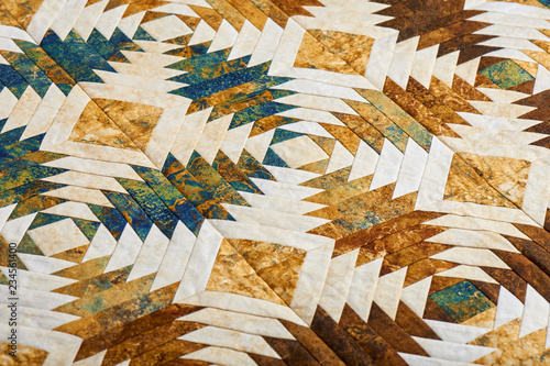 Fragment of quilt stitched from pineapple pattern blocks photo