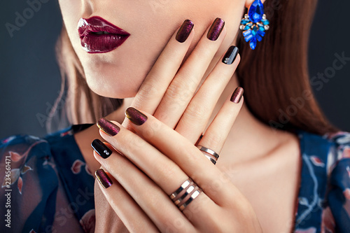 Beautiful woman with perfect make-up and manicure wearing jewellery