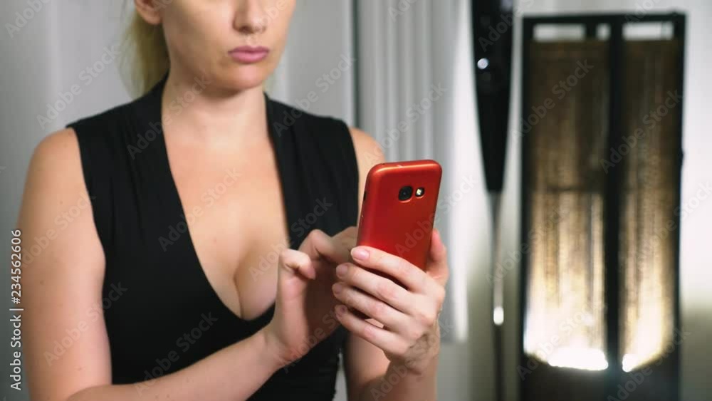 Portrait of young serious woman , in the evening and using the smartphone with touchscreen. Portrait of young serious woman , in the evening and using the smartphone with touchscreen.