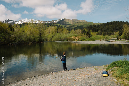 Young boy fishing at a lake