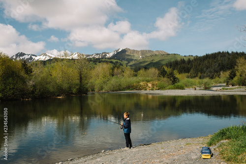 Young boy fishing at a lake