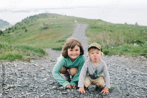 Two girls crouching on a road