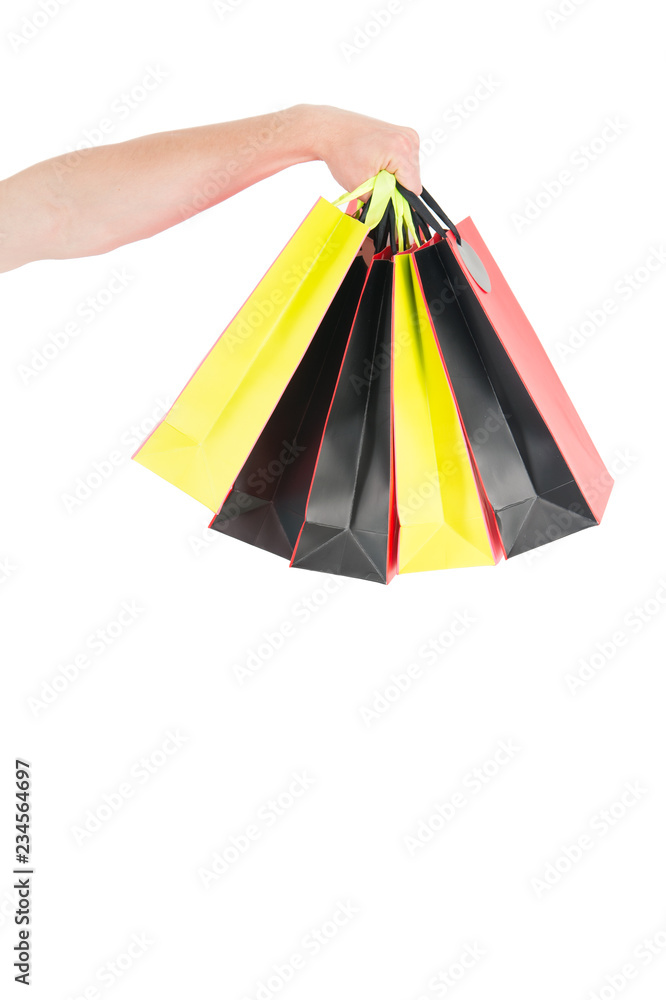 Shopping bags in hand isolated white background. Paper bags packages. Shopping and package concept. Holidays preparation shopping. Bunch of shopping bags in male hand copy space