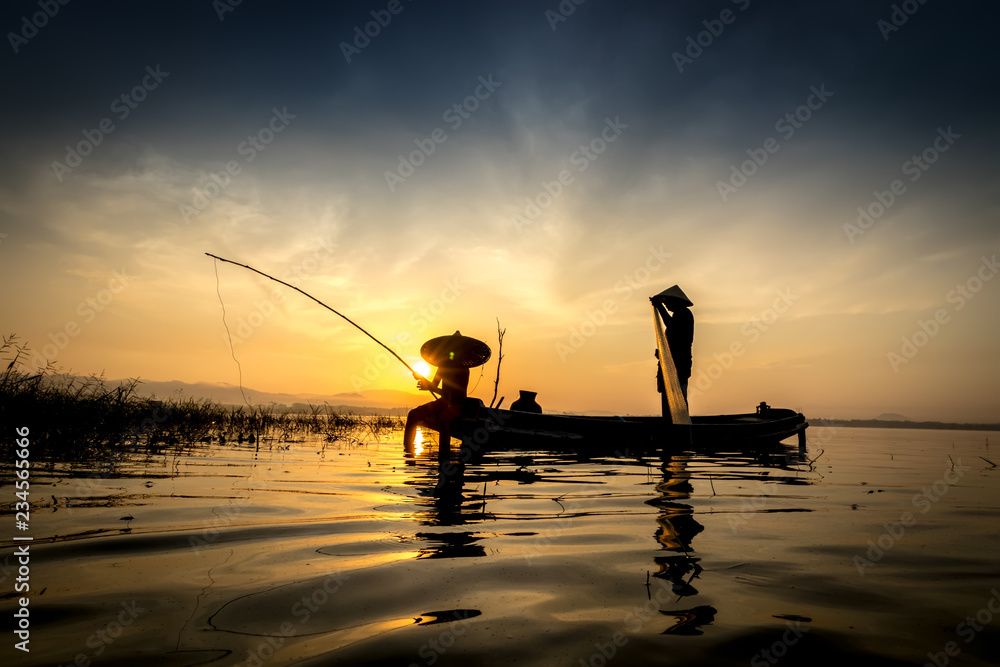 Fishermen Fishing rod with hook are going out to fish early in the morning with wooden boats, old lanterns and nets. Concept Fisherman's life style